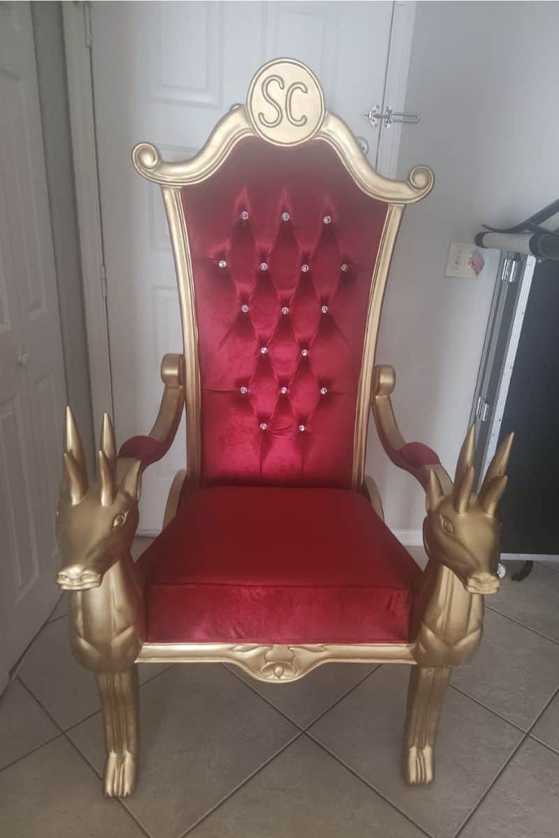 Santa chair photos: empty gold and red chair with reindeer-head armrests on tile.
